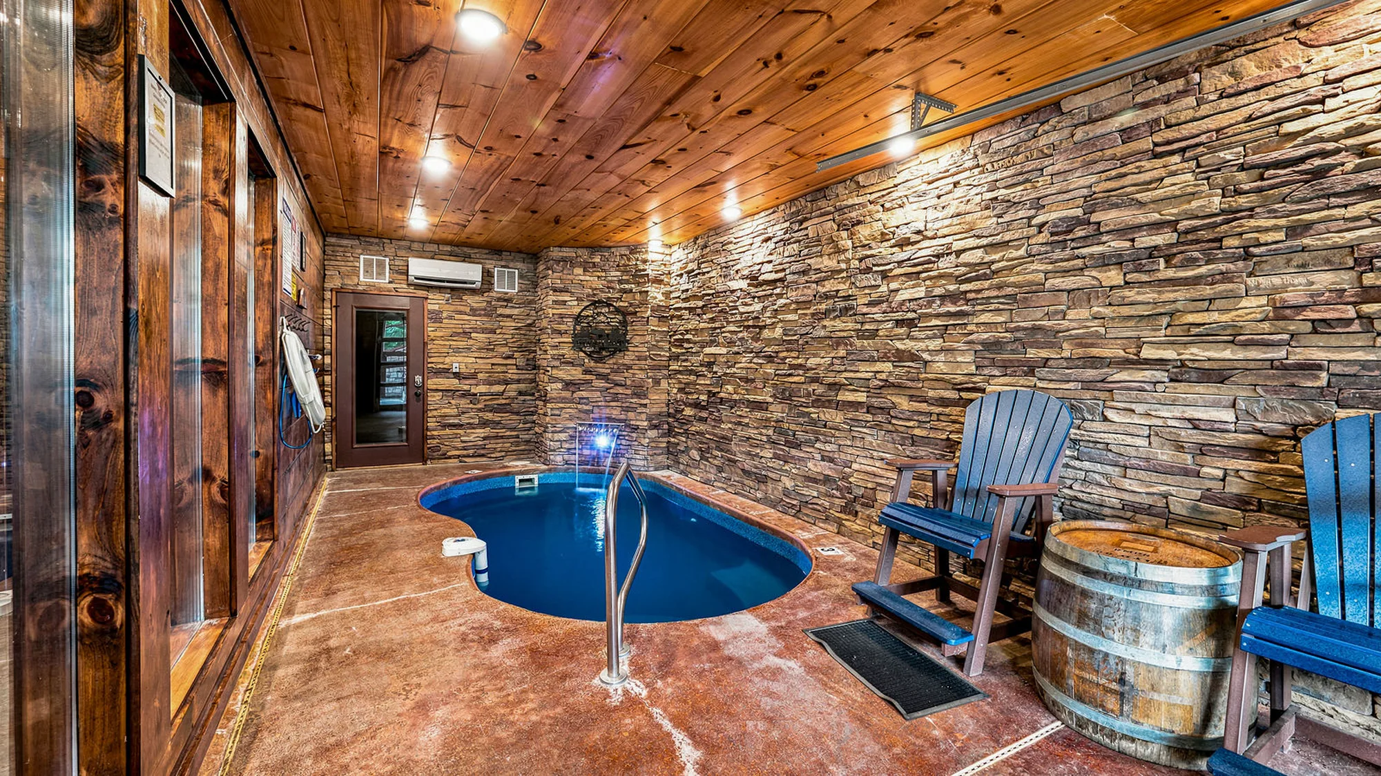 Indoor heated pool at Barrel Top Lodge, with a barrel in the seating area
